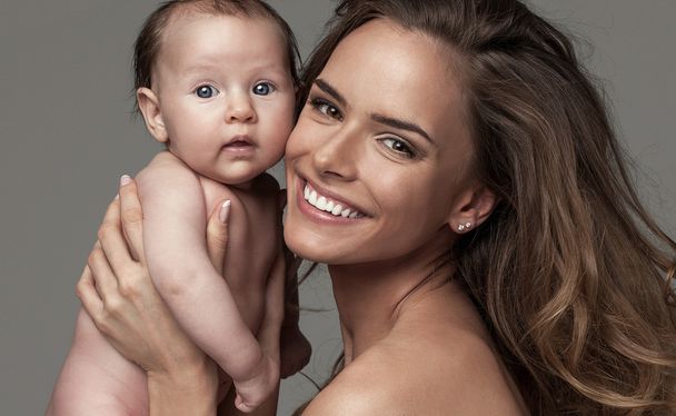 Portrait of happy woman with baby - Фото, изображение