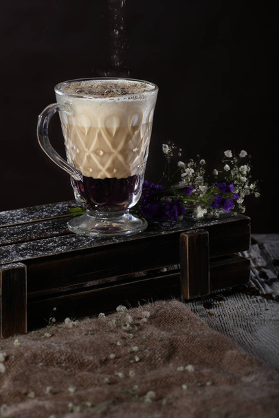 Coffee with lavender syrup. Drink exfoliating agent. Non-alcoholic coffee drink . Sprinkle dried spices on top.The macro photo on a black background. - Fotografie, Obrázek