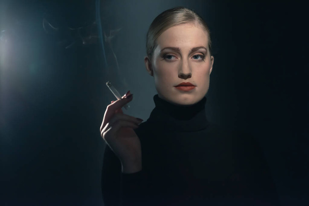 Retro 1940s woman with cigarette in black turtleneck sweater. - Zdjęcie, obraz