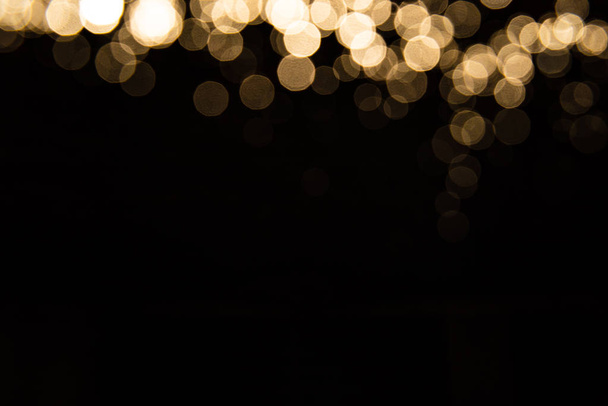 Abstract gold bokeh with black background - Фото, изображение