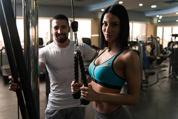 Woman With Personal Trainer At Triceps In Gym - Foto, Imagen