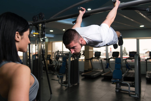 Man Doing Pull-Ups Exercises With Gym Coach - Photo, Image