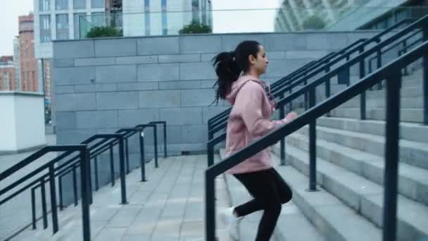 Athlete woman running up stairs on outdoor workout. Fit girl jogging upstairs - Video