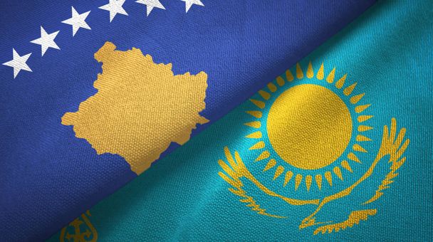 Kosovo en Kazachstan twee vlaggen textiel doek, stof textuur - Foto, afbeelding
