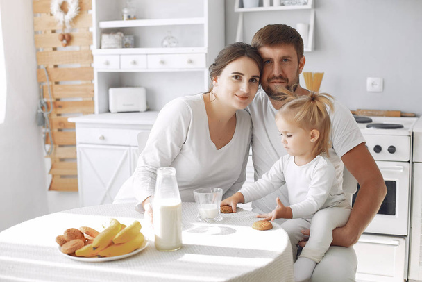 Family sitting in a kitchen and have a breakfast - Valokuva, kuva