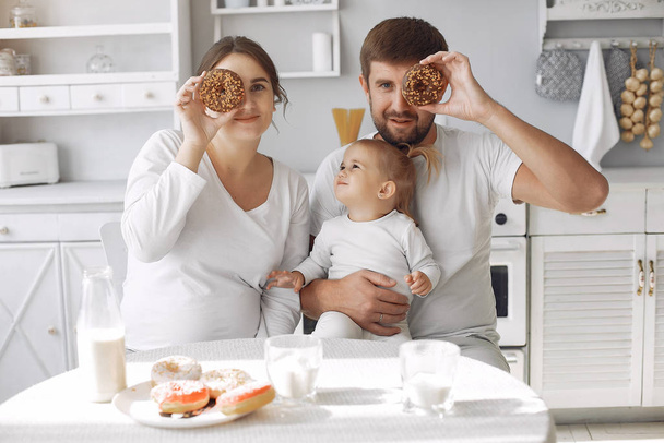 Family sitting in a kitchen and have a breakfast - Фото, изображение
