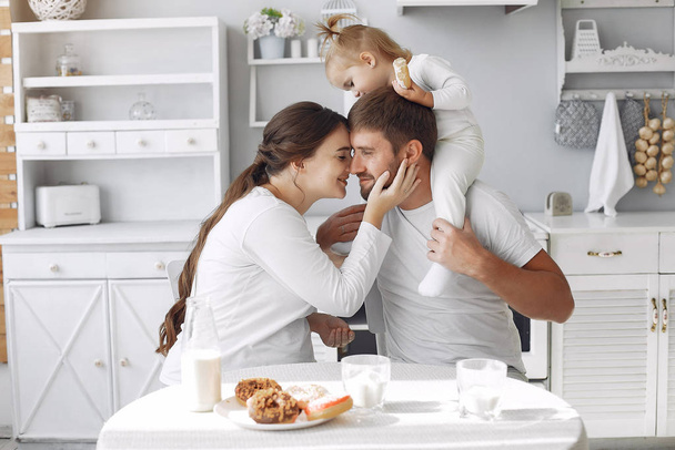 Family sitting in a kitchen and have a breakfast - Foto, afbeelding