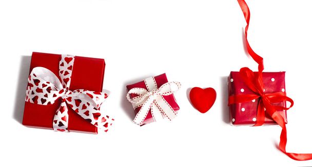 Holiday gifts. Red gift boxes on pinkbackground. Valentines day  - Φωτογραφία, εικόνα