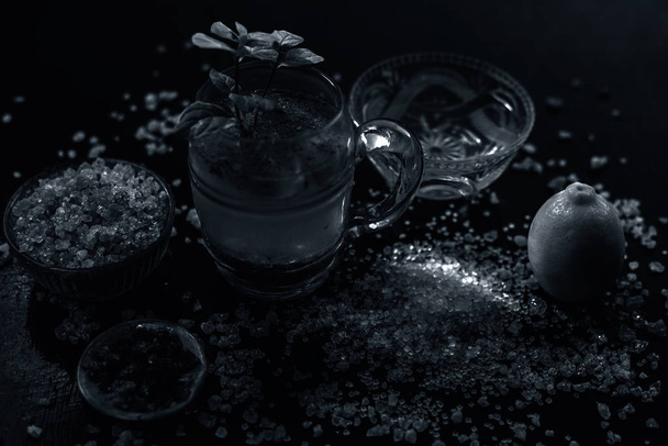 Special gond katria summer drink in a glass mug on wooden surface with some black pepper and lemon juice in it.Along with some spread gond, gum,edible gum crystals.Shot with entire constituting items. - Photo, image