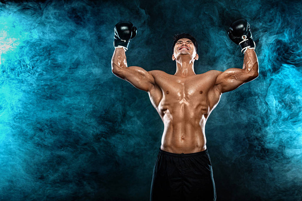 Fitness and boxing concept. Boxer, man fighting or posing in gloves on black background. Individual sports recreation. - Photo, image