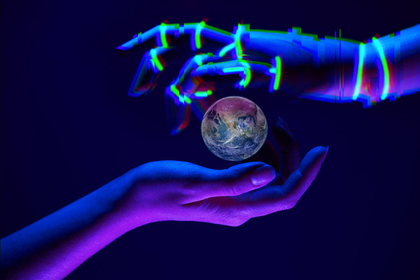 Earth between woman and robots hands as symbol of partnership between people and technology for savety nature. Elements of this image are furnished by NASA - 写真・画像