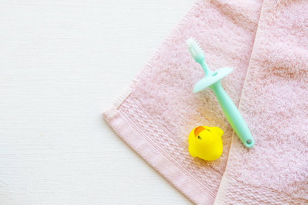 tooth brush of baby 6 months years old health care oral cavity of baby with terrry cloth arrangement flat lay style on background white  - 写真・画像