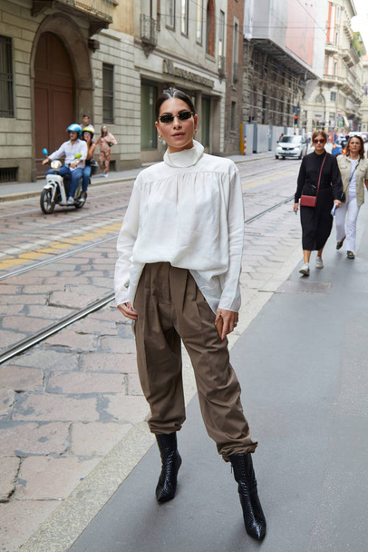 Woman with white shirt and brown trousers before Calcaterra fashion show, Milan Fashion Week street style  - Fotoğraf, Görsel
