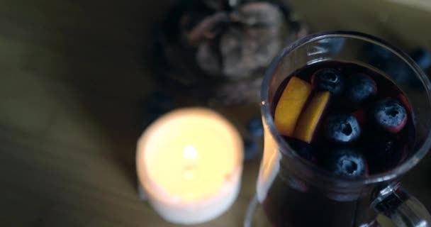 irské kávové sklo se svařenou svíčkou, borůvky, dřevěné zázemí - Záběry, video
