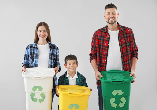 Family with containers for garbage on light background. Concept of recycling - Fotoğraf, Görsel