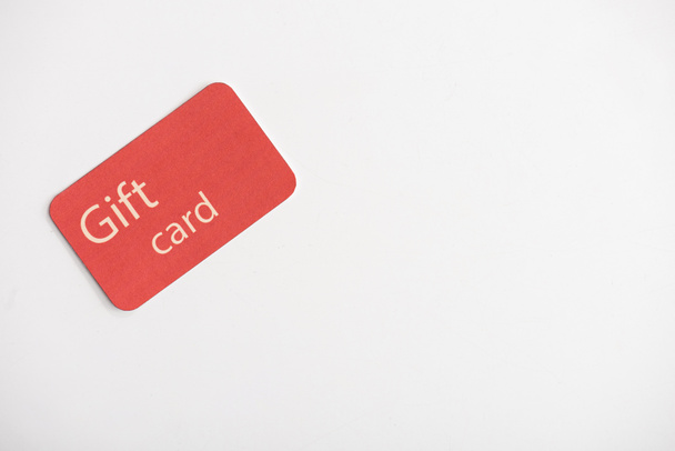 Top view of gift card on white surface with copy space - Φωτογραφία, εικόνα