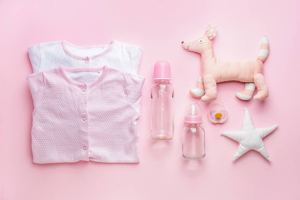 Baby clothes with accessories and toys on color background - Photo, Image