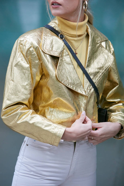 Woman with golden leather jacket and yellow turtleneck before Emporio Armani fashion show, Milan Fashion Week street style  - Zdjęcie, obraz