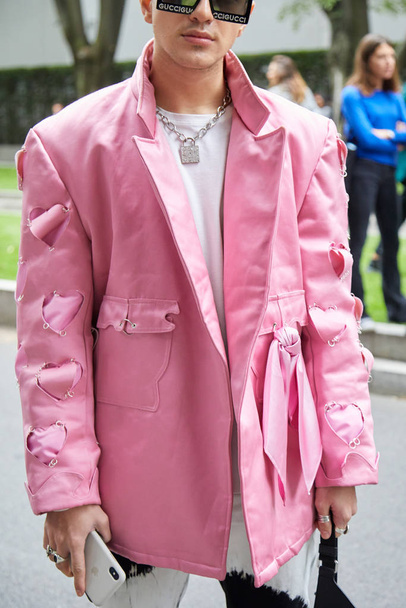 Man with pink jacket with hearts and padlock neckalce before Emporio Armani fashion show, Milan Fashion Week street style  - Zdjęcie, obraz