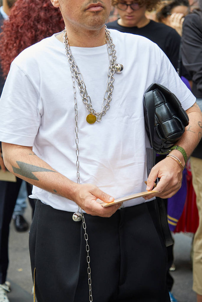 Man with white shirt, black trousers and silver chain necklace before Fendi fashion show, Milan Fashion Week street style  - Zdjęcie, obraz