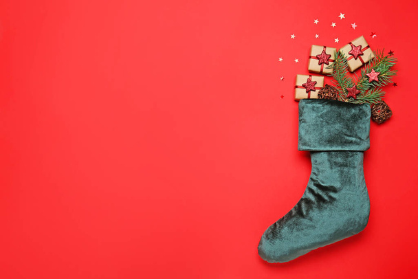 Christmas sock with gifts on color background - Photo, Image