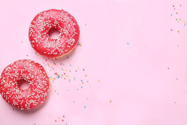 Sweet tasty donuts on color background - Foto, imagen