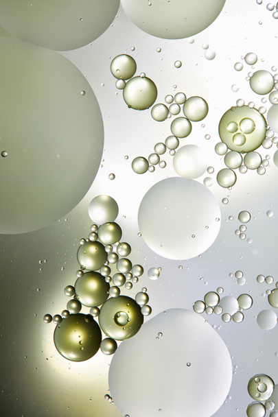 abstract background from mixed water and oil bubbles in light green and grey color - Photo, Image