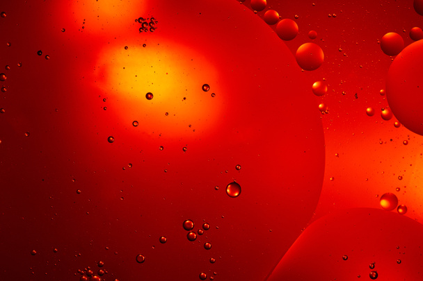 Beautiful red color abstract background from mixed water and oil bubbles - Fotoğraf, Görsel