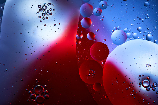 Beautiful abstract background from mixed water and oil in blue and red color - Fotoğraf, Görsel