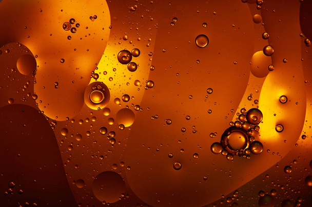 Beautiful abstract background from mixed water and oil in orange  - Fotoğraf, Görsel