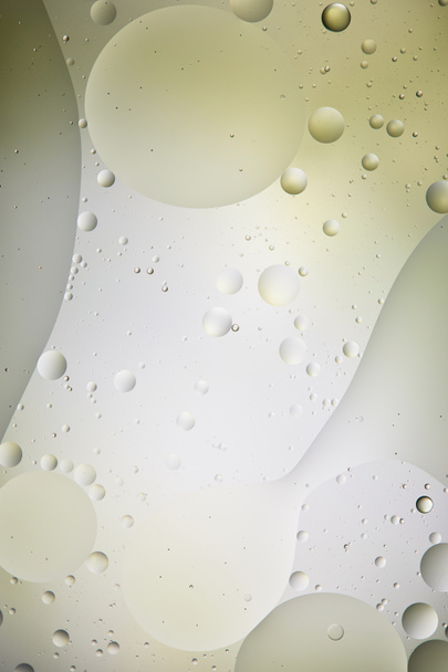 abstract background from mixed water and oil bubbles in light green and grey color - Photo, image