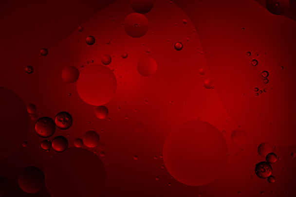 abstract dark red color background from mixed water and oil bubbles - Photo, Image