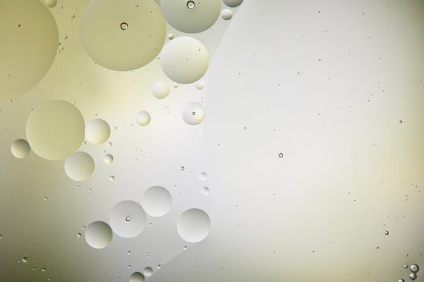 creative background from mixed water and oil bubbles in light green and grey color - Foto, imagen