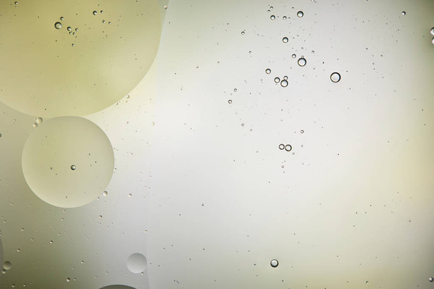 Beautiful background from mixed water and oil bubbles in light green and grey color - Foto, immagini