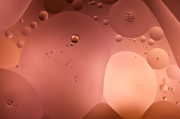 abstract background from mixed water and oil bubbles in red color - 写真・画像