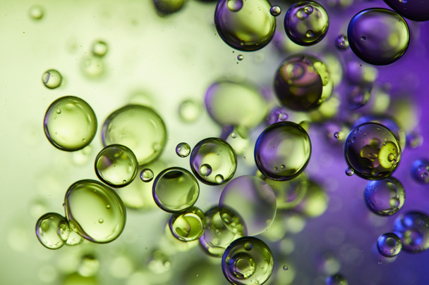 creative purple and green color abstract background from mixed water and oil bubbles - Photo, Image