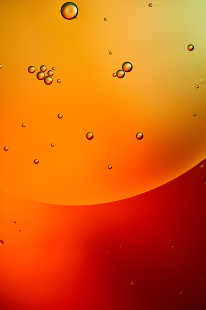 abstract background from mixed water and oil bubbles in red, orange and green color - Photo, Image