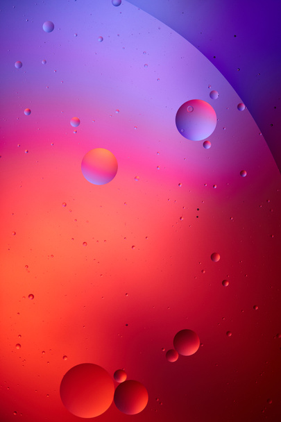 creative texture from mixed water and oil bubbles in pink and purple color - Photo, Image