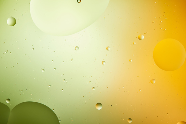 Beautiful abstract background from mixed water and oil in green and orange color - Photo, Image