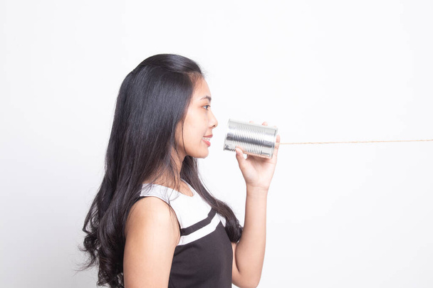 Young Asian woman with tin can phone. - Valokuva, kuva