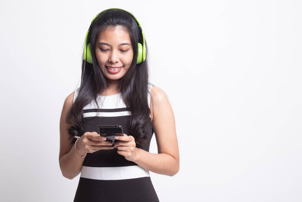 Pretty asian girl listening music with her headphones. - Fotó, kép