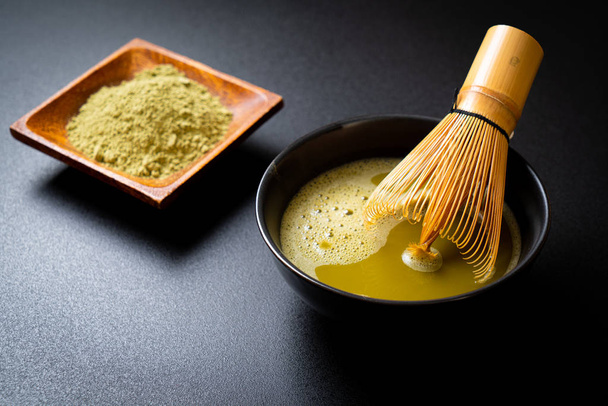 hot matcha green tea cup with green tea powder and whisk - Fotoğraf, Görsel