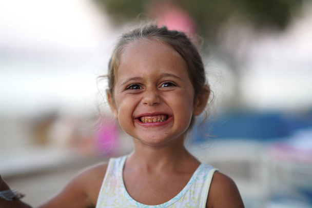 portrait of a 4 year old girl making funny faces - Photo, Image