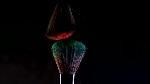 Two Soft cosmetic brushes release a cloud of colored smoke from bright eyeshadow and powder, - Filmagem, Vídeo