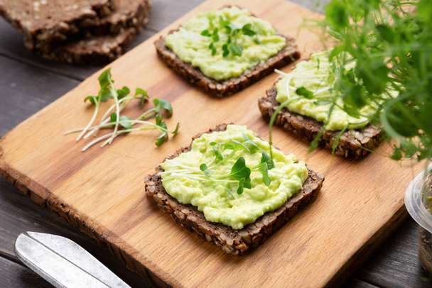 Wholegrain sandwiches with avocado spread and microgreens - Photo, Image