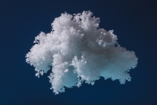 white fluffy cloud made of cotton wool isolated on dark blue - 写真・画像