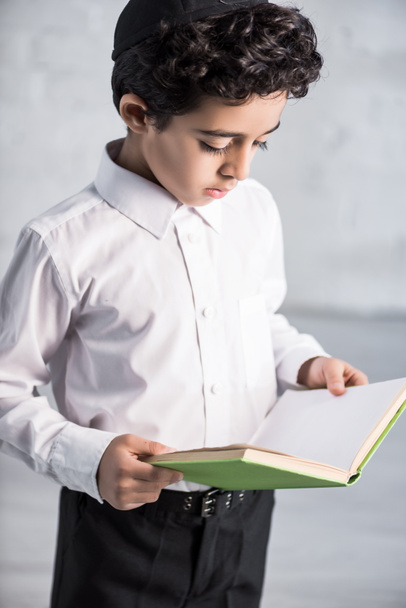 cute jewish boy in white shirt reading book  - Photo, Image