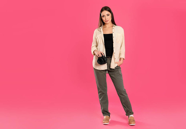 Professional photographer working on pink background in studio.  - Photo, Image