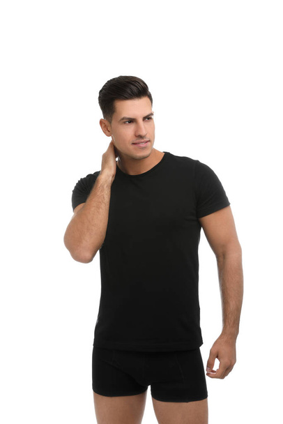 Handsome man in black underwear and t-shirt on white background - Fotó, kép