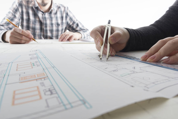 Architects working on blueprint, real estate project. Architect workplace - architectural project, blueprints, ruler, calculator, laptop and divider compass. Construction concept. Engineering tools. - Photo, Image